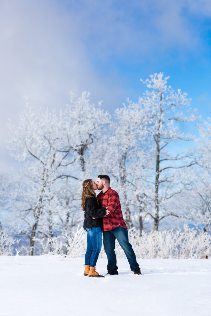 Snowy kissing engagement session photo at Bear Wallow Mountain