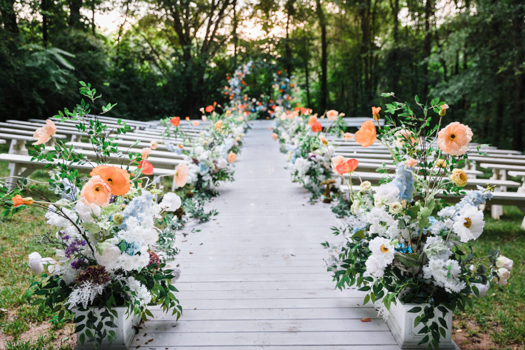 Dripping florals line the outdoor forest ceremony location at Edinburgh West.