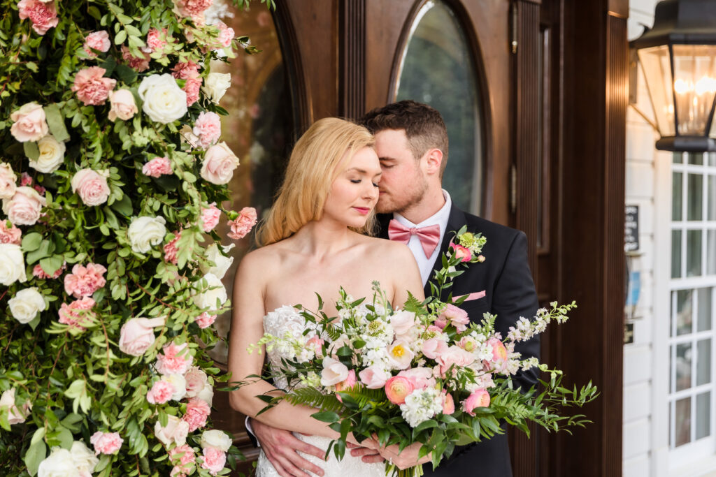 Florals planned by Greenville SC wedding planners create a stunning backdrop for this couple.